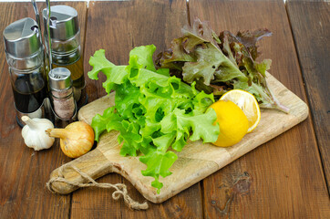 lettuce leaves on wooden cutting board, set of spices for cooking. Studio Photo.