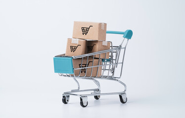 Isolated of Shipping paper carton boxes inside of shopping trolley cart on white background for...