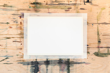 blank white sheet of paper on stained wooden board prepared for drawing