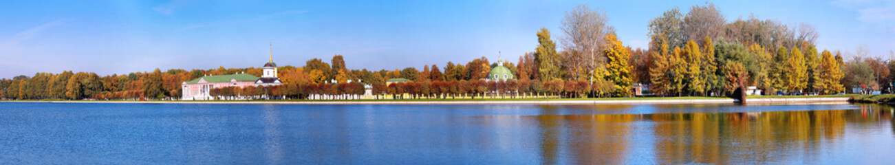 Panoramic wide angle view of pond reflections of historic Kuskovo buildings and sunny autumn park