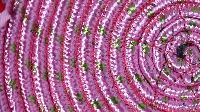Pink psychedelic circle rotates close-up.