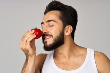 a man in a white t-shirt vegetables food diet strength isolated background