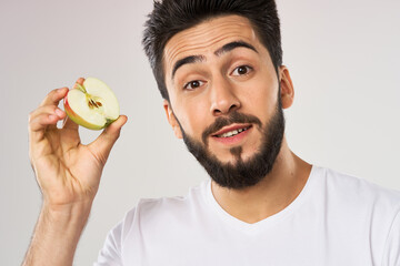 emotional bearded man with apple in his hands fruit snack
