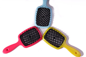 Multi-colored hair combs on an isolated white background. 