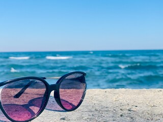 sunglasses on the beach on sea background