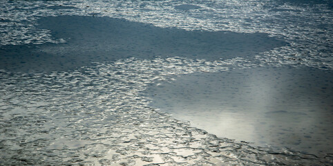Reflections of sun on a muddy surface 