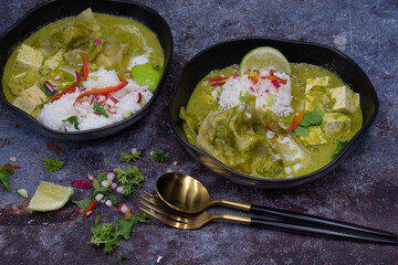 Vegan thai green curry with tofu and dumplings served with rice