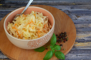 Sauerkraut in a plate. Homemade sauerkraut with carrots. Fermented food. A natural probiotic.