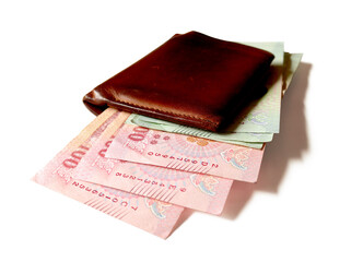 Several Thai banknotes in a brown wallet placed on a white background.