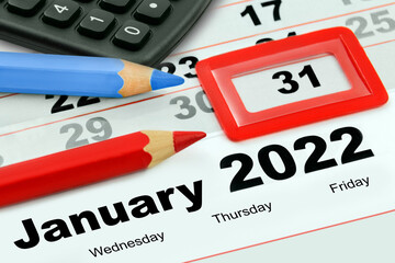 Calendar December 31 New Years Eve 2021 and January 2022 with two symbolic pencils red blue