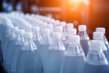 Fototapeta premium Conveyor belt with bottles of drinking water at a modern beverage plant.