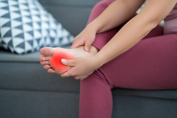 Woman's leg hurts, pain in the foot, massage of female feet at home