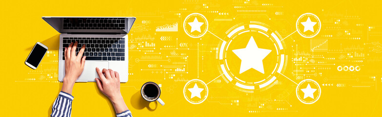 Rating star concept with person using a laptop computer