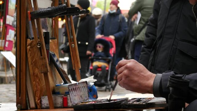 Street Artist Painter works with People Tourists in Montmartre, Paris