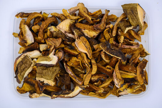tray of dried forest mushrooms on white background
