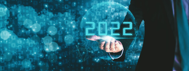 Businessman hand holding 2022 number,happy new year concept digital trends,industry and business...