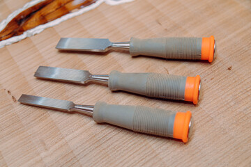 Set of chisels on wooden table