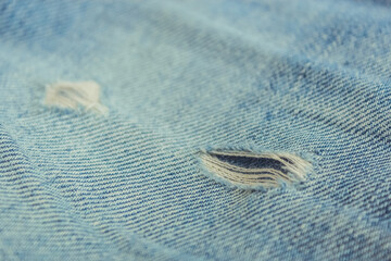 fabric ripped hole classic denim jeans close up texture