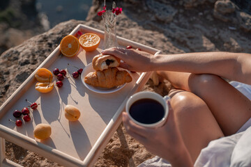 Mediterranean breakfast, cup of coffee and fresh bread on a table with beautiful sea view at the background