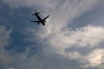 Airplane flying in the sky with clouds background