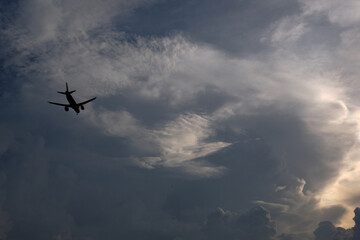 Naklejka na ściany i meble Airplane flying in the sky with clouds background