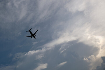 Airplane flying in the sky with clouds background