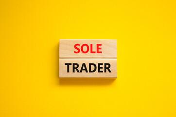 Time to sole trader symbol. Concept words Sole trader on wooden blocks on a beautiful yellow background. Business and sole trader concept. Copy space.