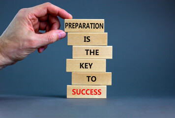 Preparation and success symbol. Wooden blocks with words Preparation is the key to success on on a beautiful grey background, copy space. Businessman hand. Business, preparation and success concept.