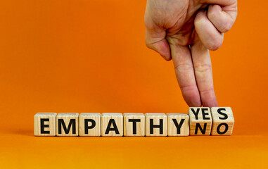 Empathy yes or no symbol. Psychologist turns wooden cubes and changes words empathy no to empathy...