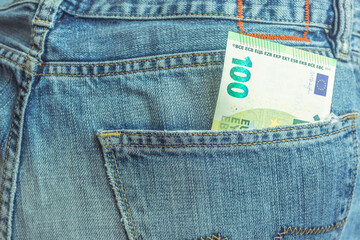 euro bill in back pocket of denim jeans