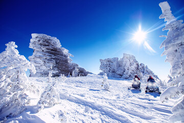 Polar arctic snow mountains with sun light. Concept travel tourist group snowmobile tour in frozen...