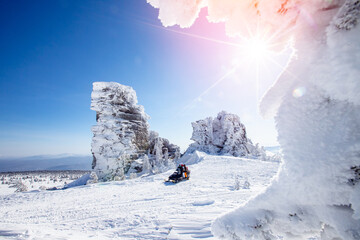 Concept travel tourist group snowmobile tour in frozen forest. Polar arctic snow mountains