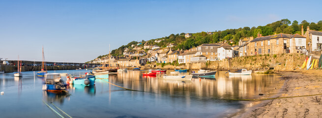 Fototapeta premium Mousehole harbour village panorama in morning light in Cornwall. United Kingdom