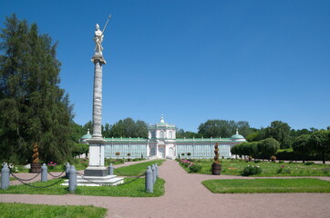Obraz premium Moscow, Russia - June 17, 2021: A column with a statue of Minerva in honor of the visits of Catherine II and a large stone greenhouse (1761-1763) in the Kuskovo Estate Museum