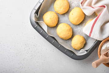 Raw yeast dough balls background in frying pan before baking. Concept home baking bread, buns or cinnabon or making dough.