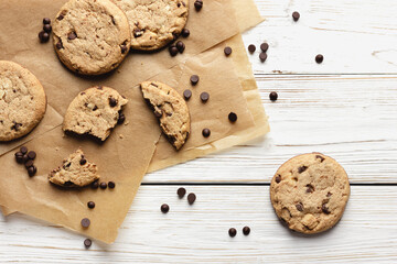 Cookies with chocolate drops on baking paper.
