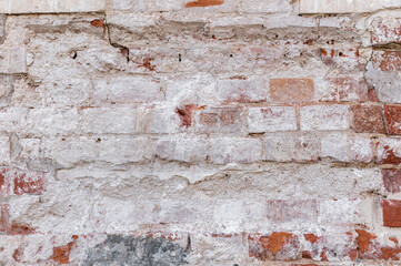 antique red brick wall, old masonry with the remains of plaster. brick background.