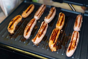 pork and beef sausages made on an electric grill