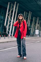 glamour woman in trendy outfit posing against the building urban background, fashion look. Outdoor fashion portrait of stylish young woman