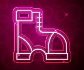 Glowing neon line Hunter boots icon isolated on red background. Vector