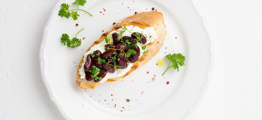 Sandwich with red beans, garlic, olive oil and curd cheese on white background. Mexican Cuisine. Top view