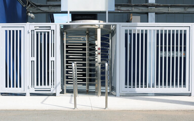 Full height gate turnstile door access control for public building.