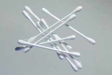 Heap of cotton swabs on a white background, hygienic cosmetic and medical supplies.