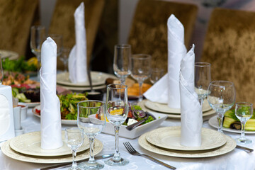 interior in the restaurant. a beautiful served table with food and utensils for the holiday