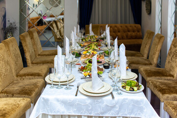 interior in the restaurant. a beautiful served table with food and utensils for the holiday