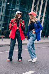 Naklejka premium Two happy girls walking near airport. Air travel, summer holiday