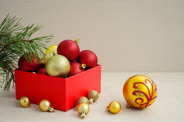 Christmas red and gold balls in a red box for decoration fir-tree.   New year winter concept. Side view, copy space.	
	
