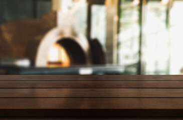 Empty wooden table top with lights bokeh on blur restaurant background.