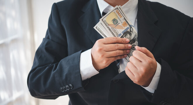 businessman was negotiating a bribery arrangement in which the dollar would be accepted as a bribe. Concepts of anti-bribery and anti-corruption.