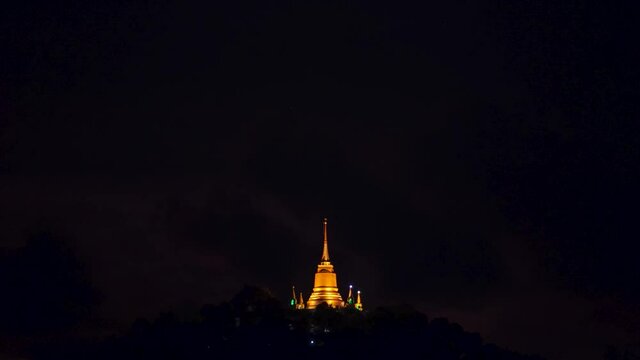 Pagoda Khao Hua Jook, the fullmoon move over Golden pagoda with warm cloud , twilight sky to moon night sky at Chaweng , Koh samui , suratthani , thailand